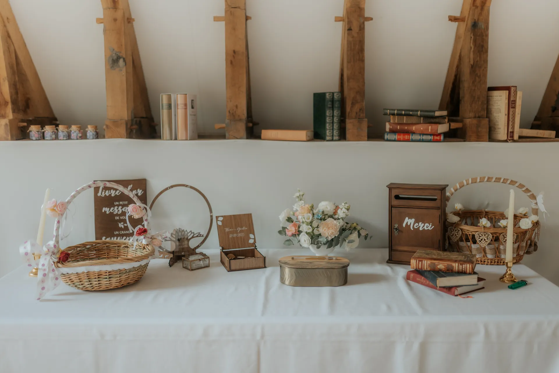 Table de décoration de mariage à Pau avec urne, fleurs et paniers dans une salle de réception chaleureuse