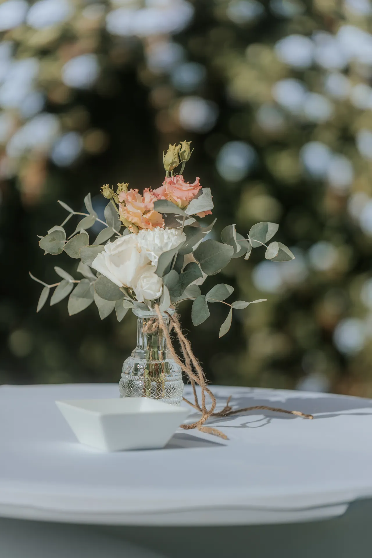 Décoration de table de mariage à Pau avec bouquet champêtre dans un vase, idéale pour une réception dans les Pyrénées-Atlantiques