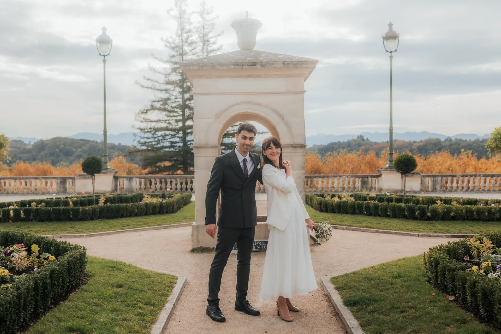Couple de mariés posant au jardin avec vue sur les Pyrénées lors d’une séance photo mariage à Pau