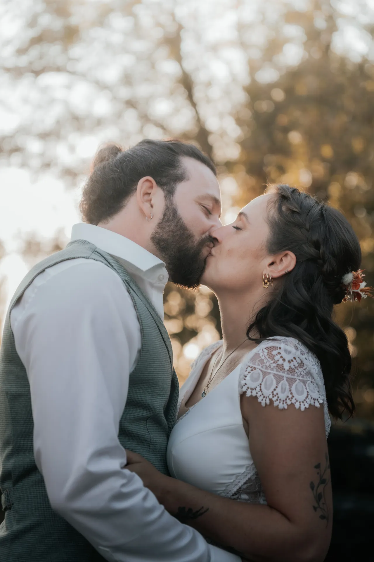 Couple de mariés s’embrassant en lumière dorée à la Villa des 7 Moulins à Lescar, cadre idéal pour des photos de mariage