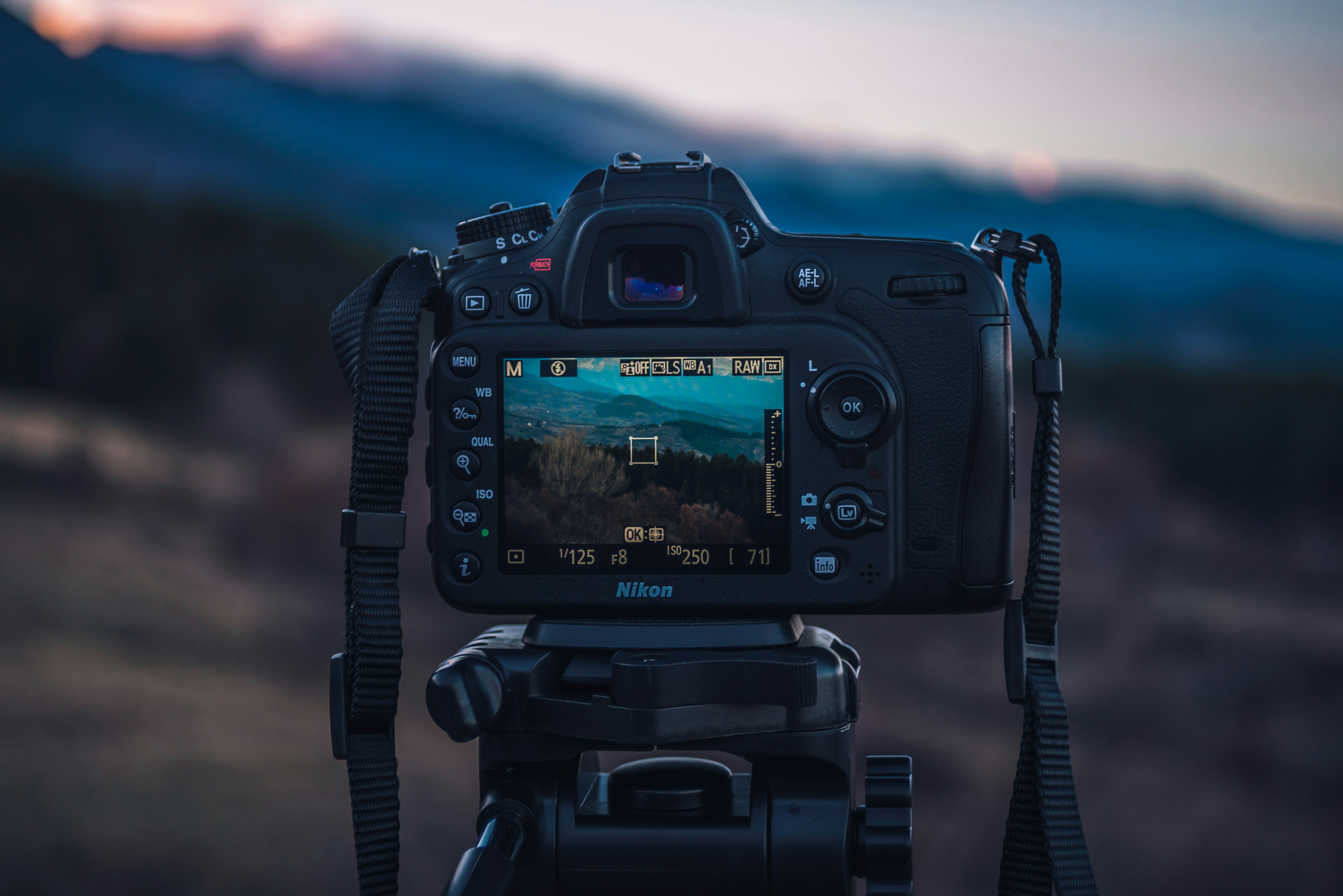 Appareil photo numérique sur trépied en montagne, idéal pour comparer les boîtiers photo et choisir son matériel